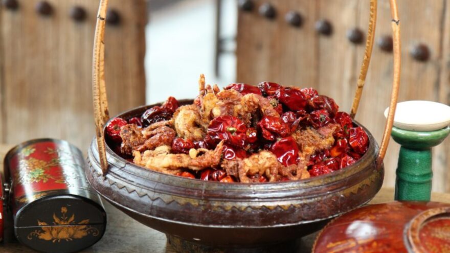 A basket of dried chillis and chicken and spices sitting outside of Hutong, an Asian restaurant in the City of London.